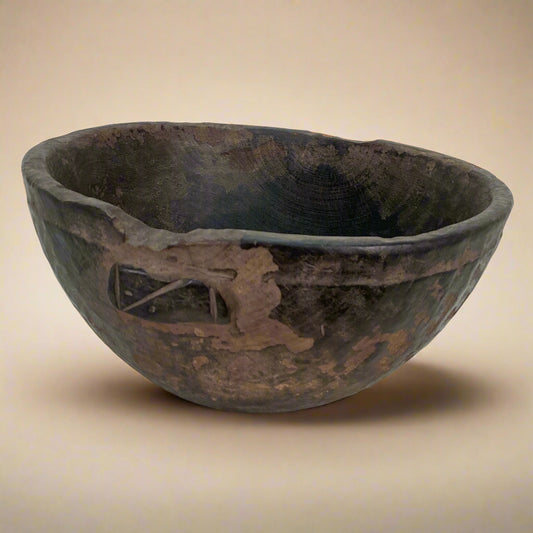 Vintage wooden bowl with a decorative carvings on a white background