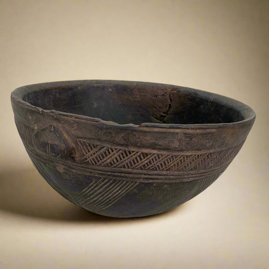 Wooden bowl with geometric patterns on a white background