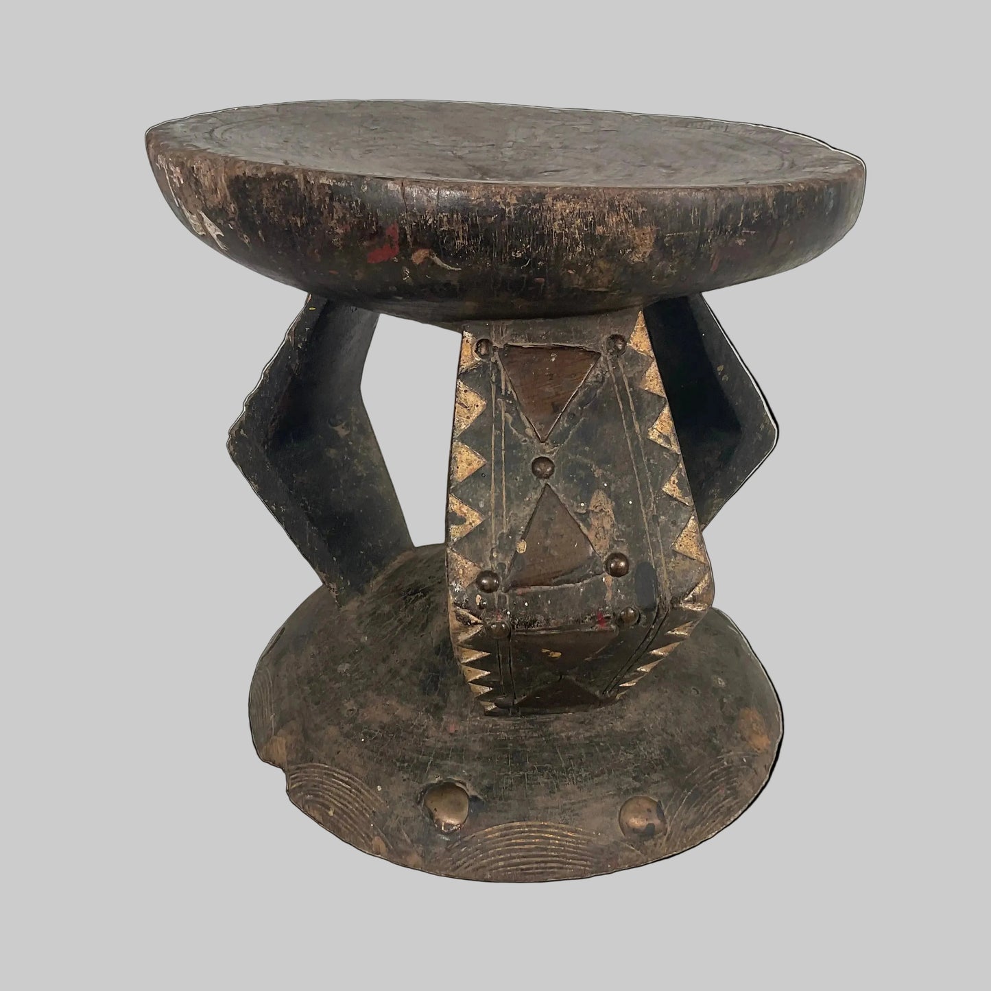 Wooden stool with a unique design on a textured surface