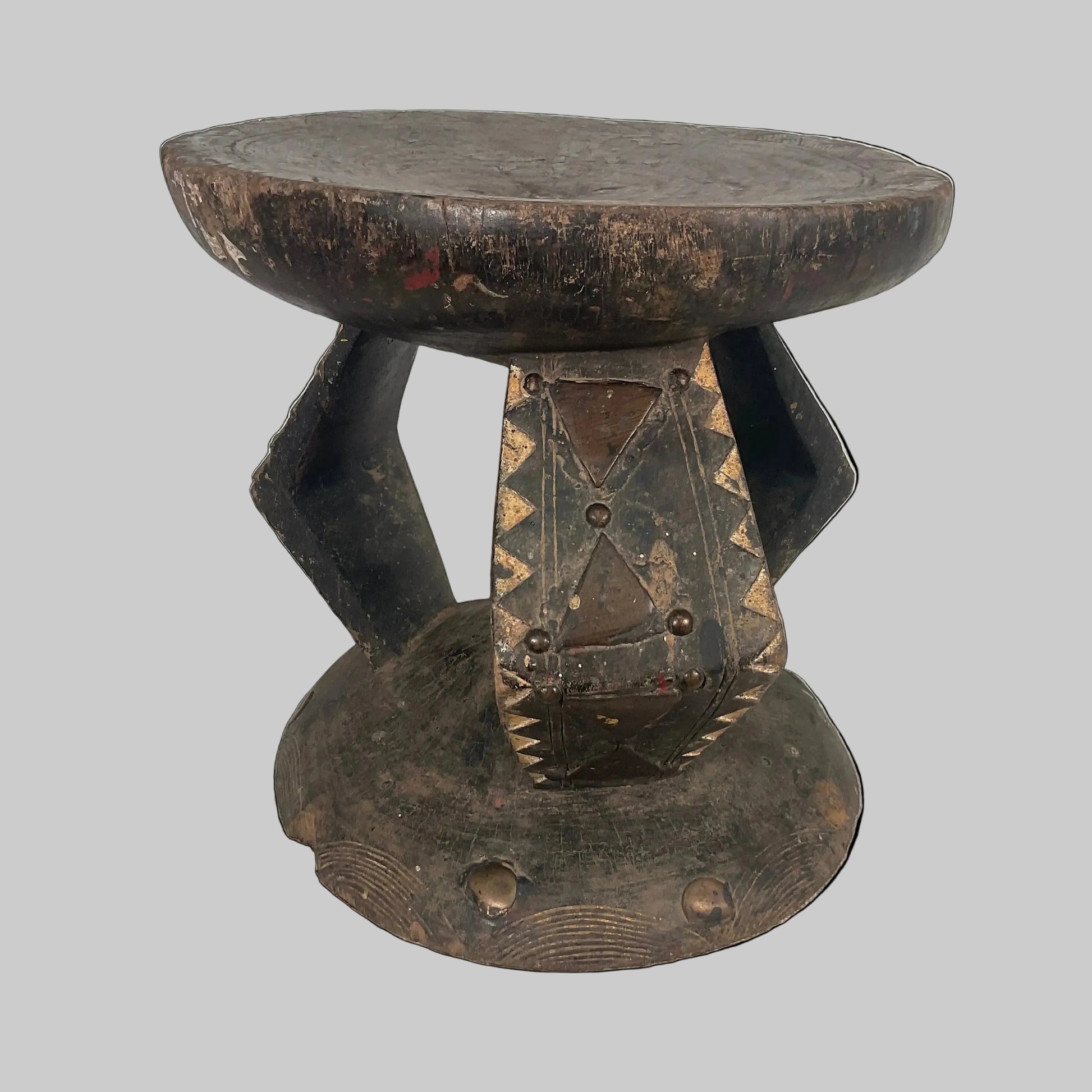 Wooden stool with a unique design on a textured surface